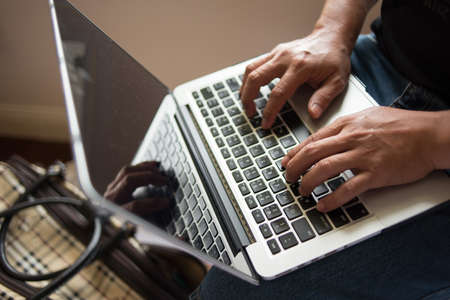 Man working with laptop, man's hands on notebook computerの写真素材
