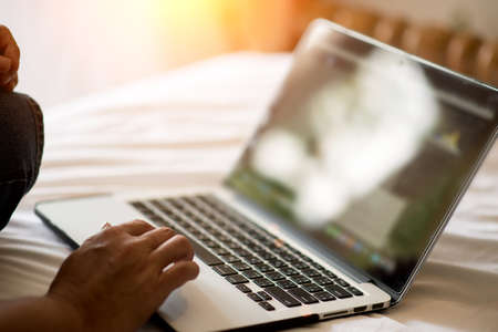 Young man working with laptop, man's hands on notebook computer