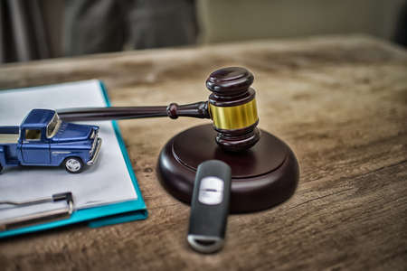 Auction hammer with golden details, a car key next to it and a contract,High Dynamic Range toneの写真素材
