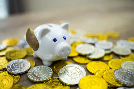 piggy bank and bitcoin on table with save futureの写真素材