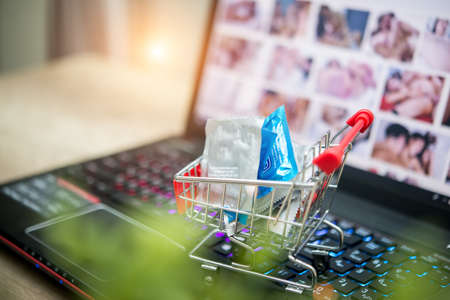 Condoms shopping cart depicting the idea of paying for sex onlineの写真素材