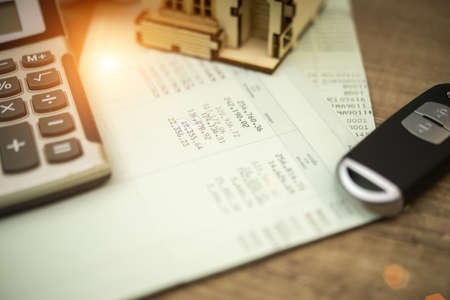 close up of calculator ,car remote and account book in finance and banking conceptの写真素材
