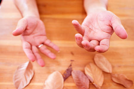 Tremor from Parkinson's disease in hands man,red toneの写真素材