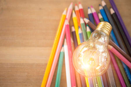 Concept idea of education Coloring pencils in glass jar Or return to school on a light cream background .の写真素材