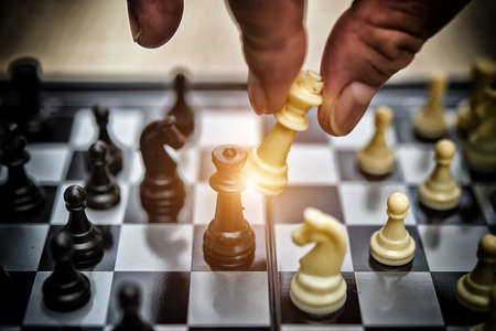 Hand of businessman playing chess,High dynamic range toneの写真素材