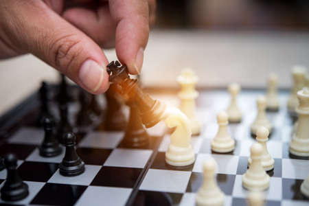 Hand of businessman playing chessの写真素材