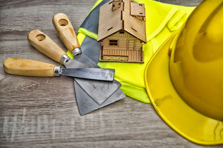 Composition with safety helmet, leather gloves, tools and decorative house,High dynamic range toneの写真素材