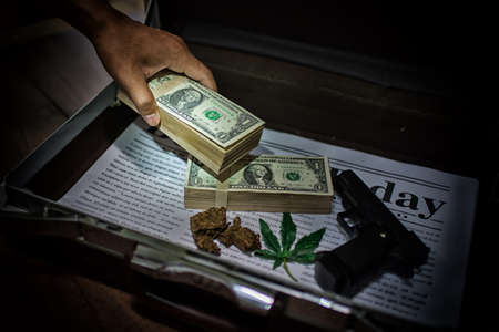 Money for business and gun,corruption concept,High Dynamic Range toneの写真素材