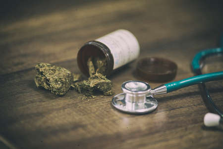 stethoscope and Cannabis used for healing on wooden background,vintage toneの写真素材