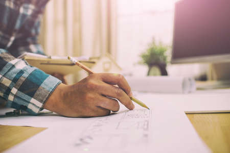 man working of Architect sketching a construction project on his planeのeditorial素材