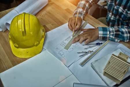 Man working of Architect sketching a construction project on his plane,High Dynamic Range tone