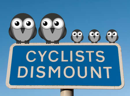 Family of birds perched on a Cyclist Dismount road sign against a clear blue skyの写真素材