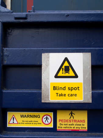 Signs on back of heavy goods  vehicle warning pedestrians
