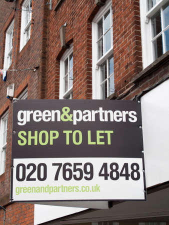 Newbury, Northbrook Street, Berkshire, England - June 16, 2017: Estate Agent Green and Partners shop to let sign over vacant retail propertyのeditorial素材