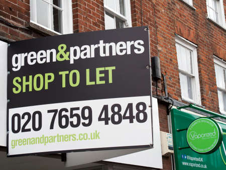 Newbury, Northbrook Street, Berkshire, England - June 16, 2017: Estate Agent Green and Partners shop to let sign over vacant retail propertyのeditorial素材
