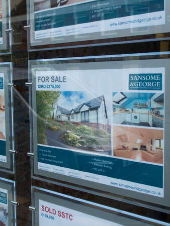 Residential properties for sale displayed in estate agents window