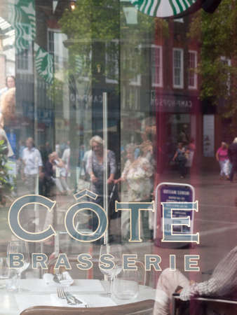 Cote Brasserie French restaurant name with street scene reflected in glass windowのeditorial素材