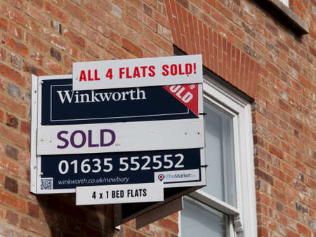 Estate Agent sign above properties showing all four residential flats soldのeditorial素材
