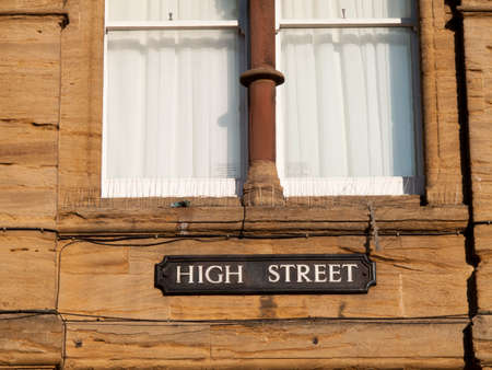 High Street place name on historic stone buildingのeditorial素材
