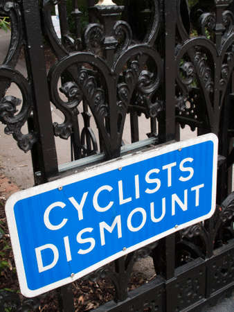 Cyclist dismount highway information sign mounted on iron railingsのeditorial素材