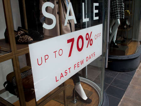 Seventy percent off last few days sale sign in clothing shop windowのeditorial素材
