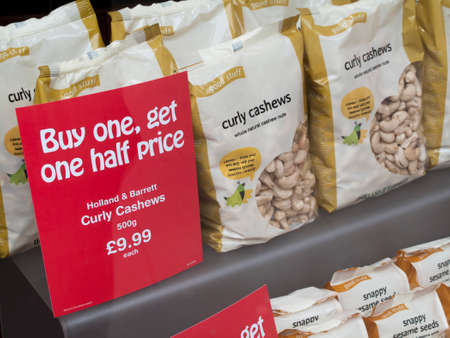 Holland and Barrett curly cashews window display, company formed in 1870 by Alfred Slapps Barrett and Major William Hollandのeditorial素材