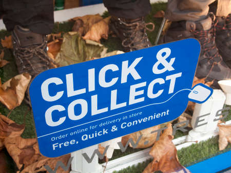 Click and collect sign in retail shop window, order online for free delivery in storeのeditorial素材