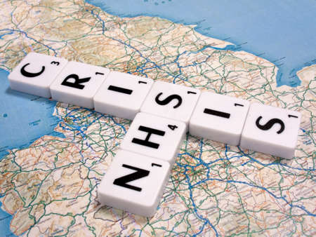 representation of the funding and staffing crisis effecting the National Health Service on United Kingdom map backgroundのeditorial素材