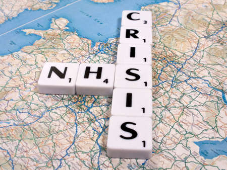 representation of the funding and staffing crisis effecting the National Health Service on United Kingdom map backgroundのeditorial素材