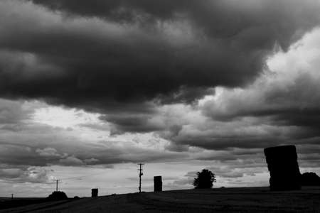 Dramatic monochrome storm clouds over farmland in rural Hampshireの写真素材
