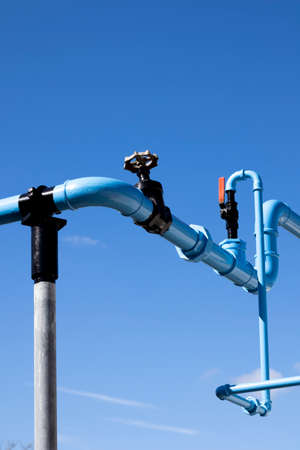 Blue painted pipework supplying compressed air to manufacturing buildingsの写真素材