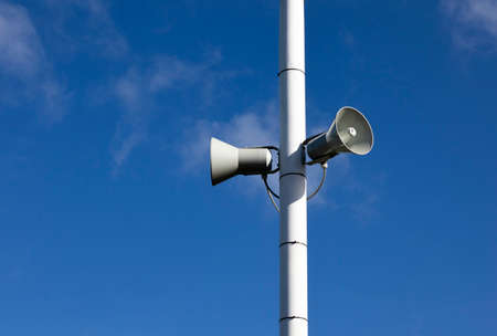 PA public address system speakers fixed to timber telegraph poleのeditorial素材