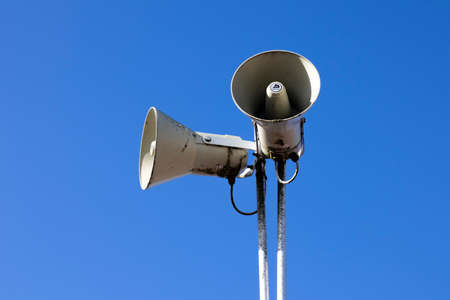 PA public address system speakers fixed to timber telegraph pole