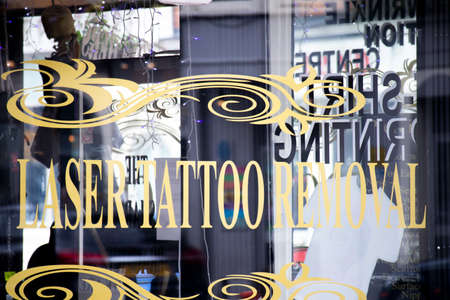 The Sharp Practice tattoo and piercing studio shopfront window advertising laser tattoo removalのeditorial素材