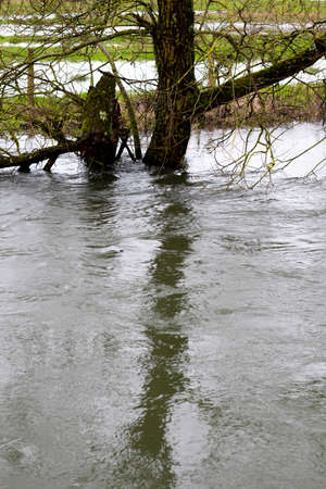 Flooded river after heavy storm rainfall flooding adjacent farmlandの写真素材