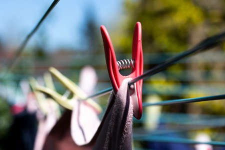 Laundry out to dry pegged to a rotary airer on a warm sunny spring day with sallow depth of fieldの写真素材