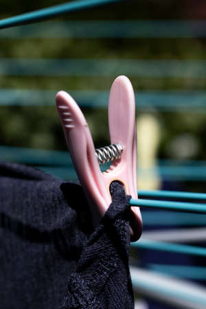 Laundry out to dry pegged to a rotary airer on a warm sunny spring day with sallow depth of fieldの写真素材