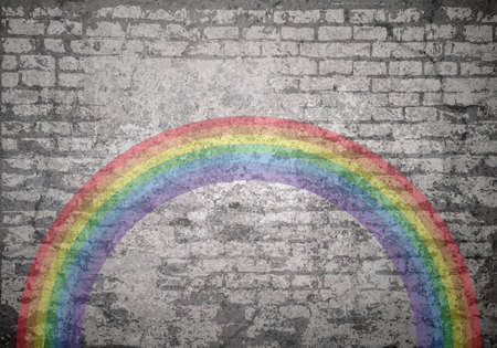 Grunge decayed faded brick wall background with a rainbow which has become a symbol of support for people wanting to show solidarity with healthcare workersの写真素材