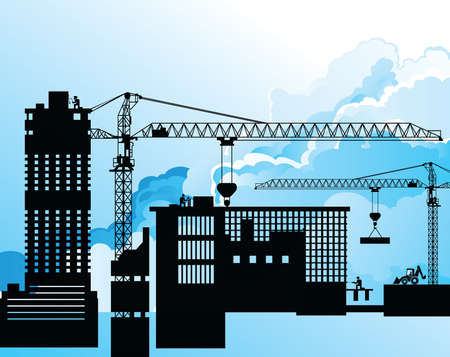 Silhouetted generic urban construction development set against a blue cloudy skyの写真素材