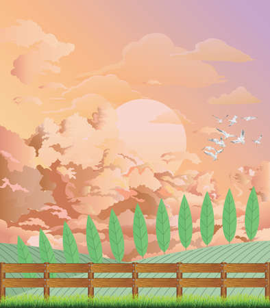 Picturesque rural country scene with farmland and boundary fence with pink morning dawn sky aboveの写真素材
