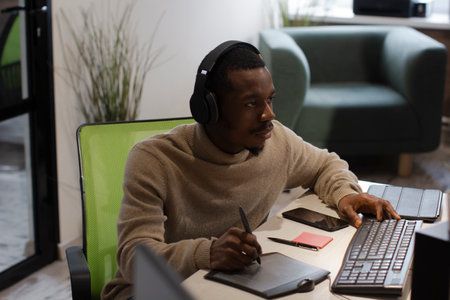 African American artist draws on tablet 3D model for computer game