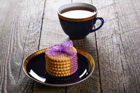 Cup of tea with cookies on wooden backgroundの写真素材