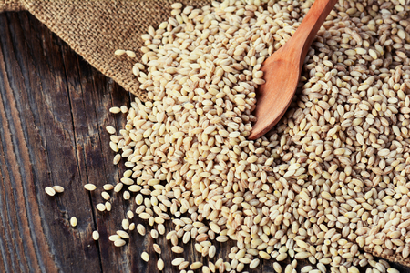Pearl barley grain on a wooden tableの写真素材