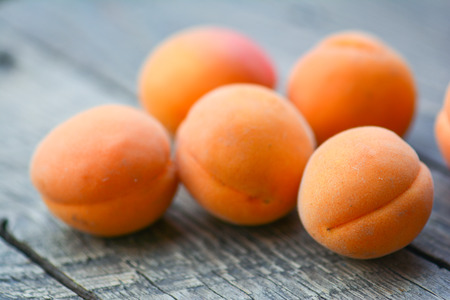 Apricots in the garden on a wooden tableの写真素材