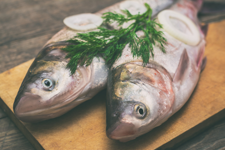 Fresh fish on a wooden tableの写真素材