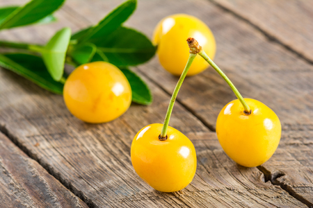 Yellow cherry on a wooden backgroundの写真素材
