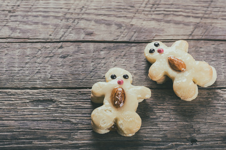 Cookies in the form of funny characters on wooden background