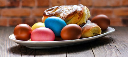 Colorful festive easter eggs and easter sweet bakingの写真素材