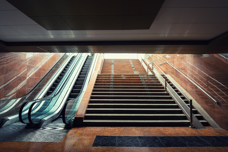 Escalator and staircase in the underground passageの写真素材