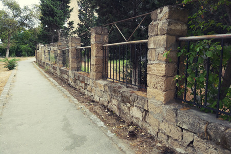 Old stone fence walking path in cityの写真素材